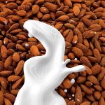 plant-based milk: milk splashes down onto almonds