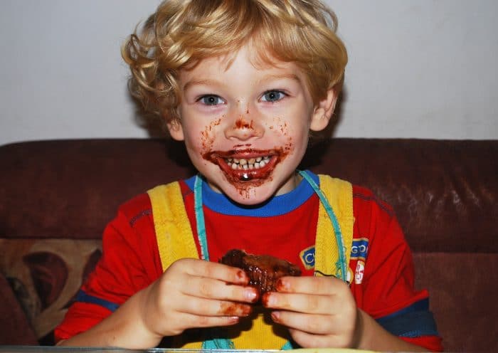Little boy eating chocolate